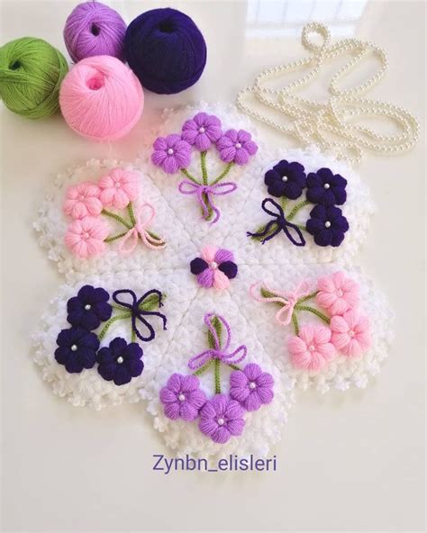 Several Crocheted Flowers And Yarn On A White Surface With The Wording