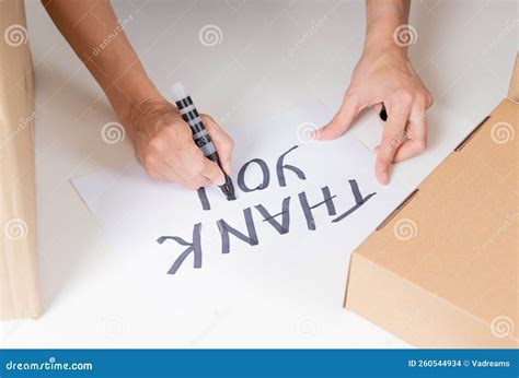 Woman Hand With Black Marker Writing Thank You On White Paper Donation