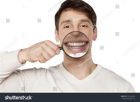 Smiling Young Man Holding Magnifying Glass Stock Photo 352242944