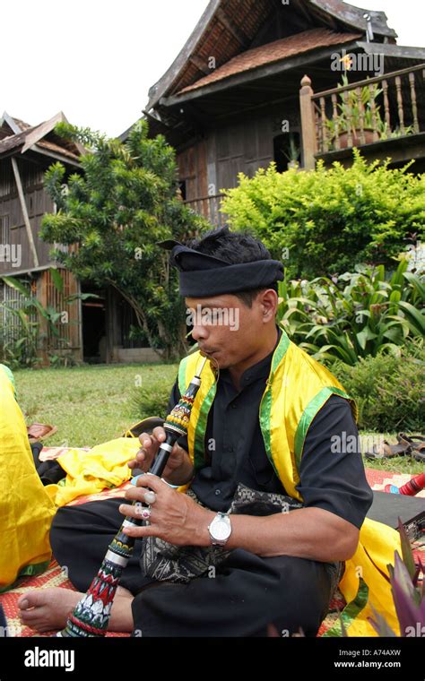 A Man Blowing The Clarinet During The Performance Of The Malay Art Of