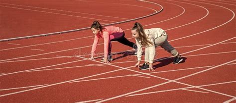 Healthy Children Girls Training Run On Stadium Running Track Sport