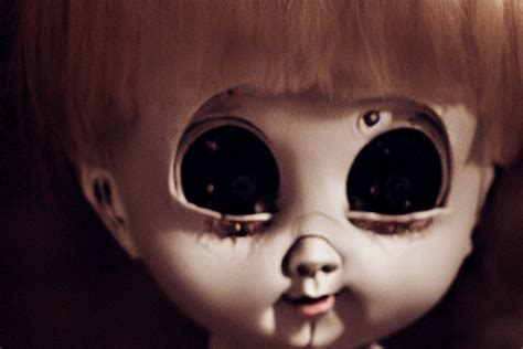 A Creepy Doll With Human Eyes Staring Out At The Viewer Horror Movie