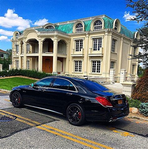 A Look At Some Mansions With Expensive Cars Parked In Front Homes Of