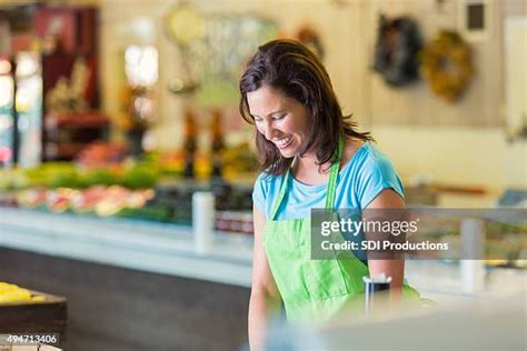 grocery store worker stocking   premium high res pictures