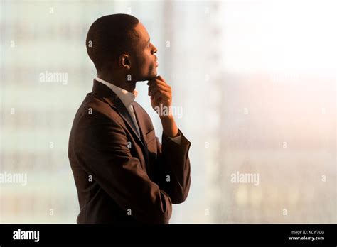 Portrait Of Pensive African American Businessman Standing Near Window