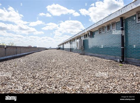 There Are Pebbles On The Roof Next To An Stone Wall Stock Photo Alamy