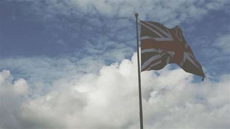 Premium Photo | British flag waving against cloudy sky