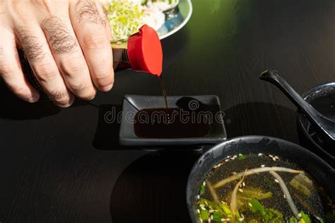 Pouring Soy Sauce In Japanese Ceramic Bowl In Sushi Restaurant Stock