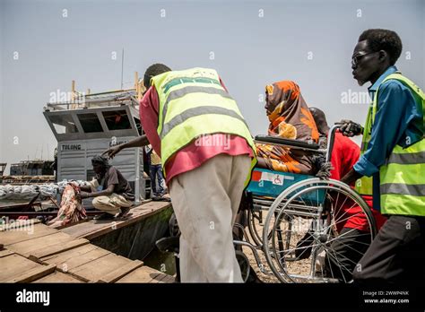 March 21 2024 Renk South Sudan A Woman In A Wheelchair Is Lifted