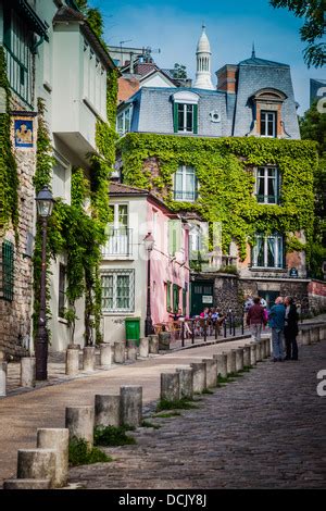 Street Scene In Montmartre With The Sacre Coeur Basilica On The