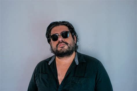 Portrait Of Handsome Hispanic Man With Beard Wearing Glasses Stock