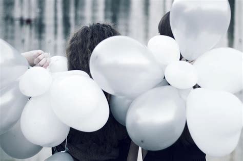 Premium Photo Close Up Of People Holding White Balloons