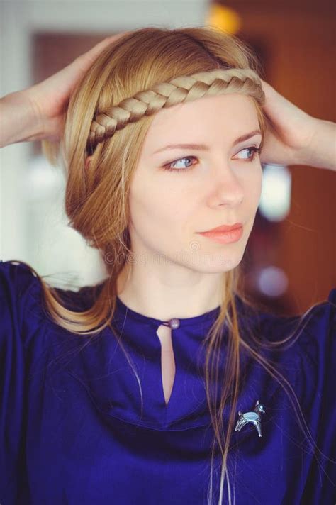 Pretty Blonde Woman With Braided Hair Playing Hands On Her Head