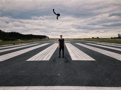 Premium Photo Man Standing On Airport Runway Against Cloudy Sky