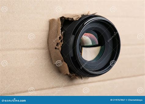 Hidden Camera Lens Through Hole In Cardboard Closeup Stock Image