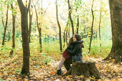 Mother And Daughter Spend Time Together In Autumn Yellow Park Season