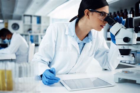 Microscope Digital Tablet And Woman Scientist In A Laboratory For