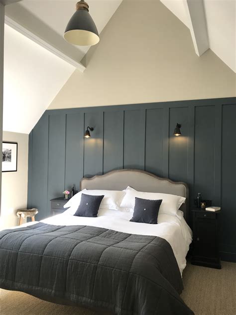 A Large Bed In A Room With Two Lamps On Either Side Of The Headboard