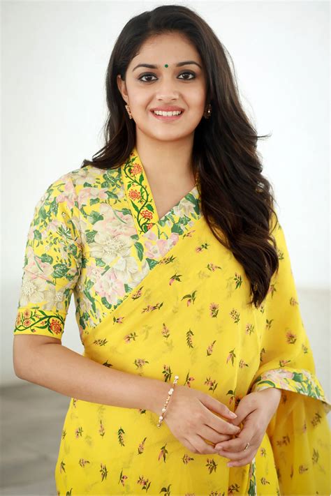 Download Vibrant Elegance Keerthi Suresh In A Stunning Yellow Floral Saree Wallpaper