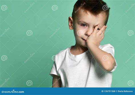 Portrait Of Unhappy Sad Bored Kid Boy Leaning Head On Palm Looking With