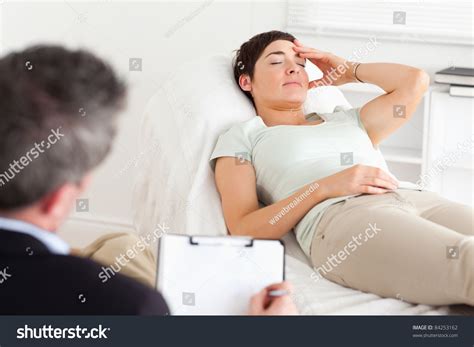 Psychologist Talking To A Depressed Patient In A Room Stock Photo