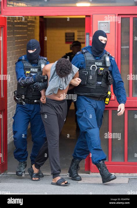 Police Officers Arrest A Man At An Address In Peckham South London During A Series Of Raids To