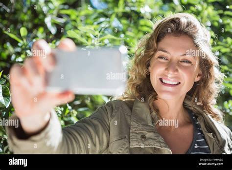 Smiling Woman Taking Selfies Stock Photo Alamy