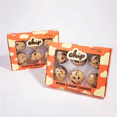 Two Boxes Of Cookies Are Shown On A White Surface With Clouds In The