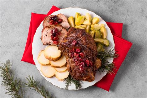 Free Photo High Angle Of Christmas Steak On Plate With Pine Cones