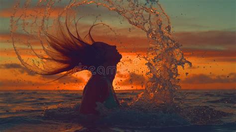 Silhouette Girl Splashes Sea Water With Her Long Hair On A Spectacular