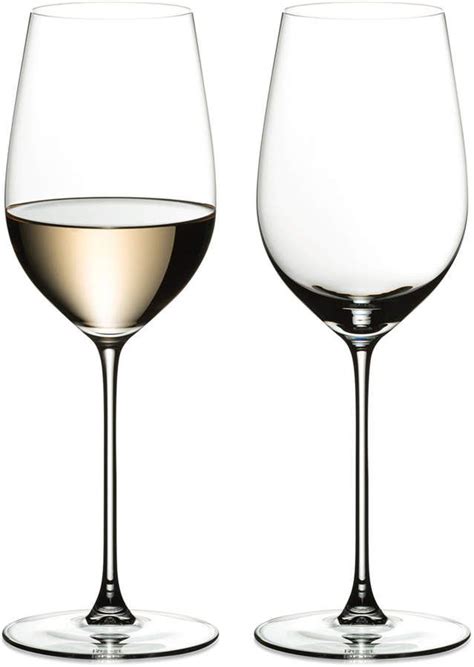 Two Empty Wine Glasses Sitting Next To Each Other