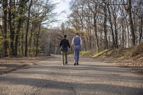 Rear View Two Gay Man Walking In Forest On Asphalt Road Stock Photo Image Of Relationship