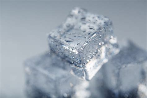 Ice Cube With Water Drops Close Up In Macro On A White Background