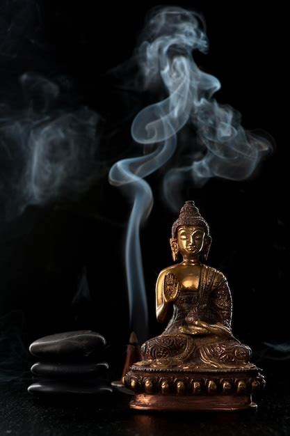 Premium Photo Buddha Statue Incense Sticks And Black Zen Stones