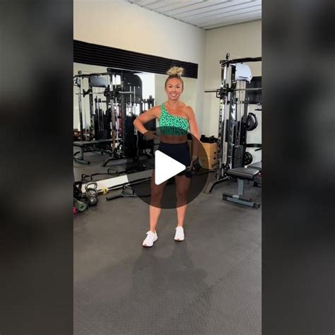 a woman standing in front of a gym machine