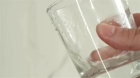 Water is poured from a glass, slow motion. 21031792 Stock Video at Vecteezy