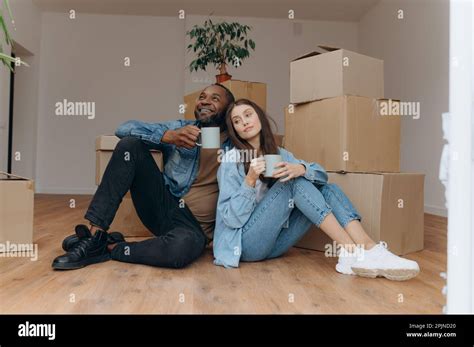 Couple Moving In House Interracial Couple Sitting Near Cardboard Boxes