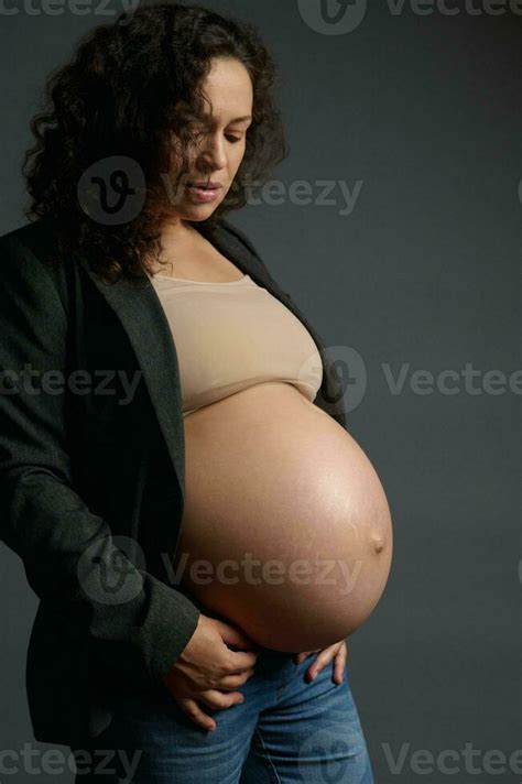 Multi Ethnic Curly Confident Expectant Mother Posing With Her Naked