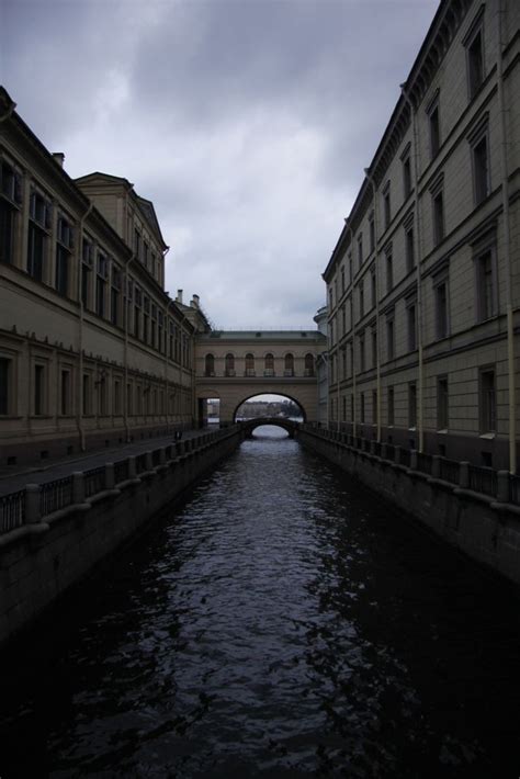 A River Running Between Two Buildings Next To Each Other