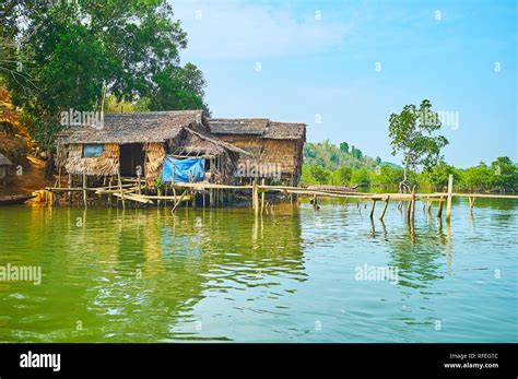 The Shabby Stilt Huts Of Nipa Palms And Wood On The Bank Of Kangy River