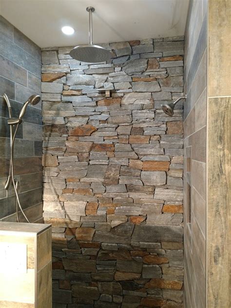 Rustic Stone And Tile Shower With 4 Shower Heads And Moen Electronic