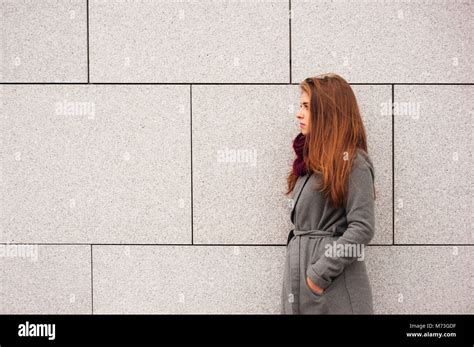 Teenager Brunette Girl With Long Hair Leaning Against A Wall Stock