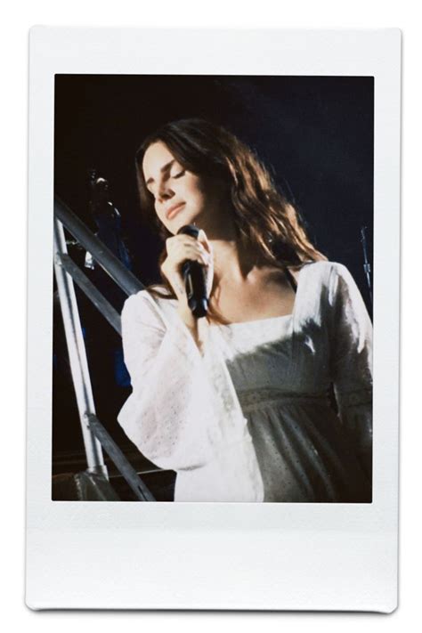 A Woman In White Dress Holding A Microphone