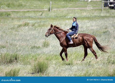 Young Asian Girl is Riding Her Pure Breed Horse in Kazakhstan Steppe ...