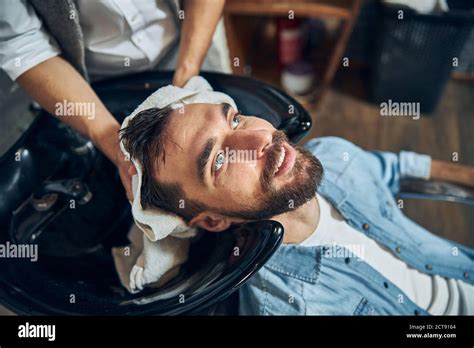 Bearded Brunette Man Getting A Barbershop Staff Dry His Hair Stock