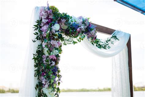 Arch For The Wedding Ceremony Decorated With Cloth And Flowers