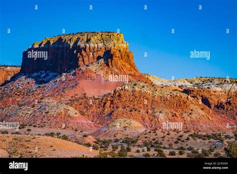 Mesa with colorful layers of sandstone and gypsum exposed after erosion ...