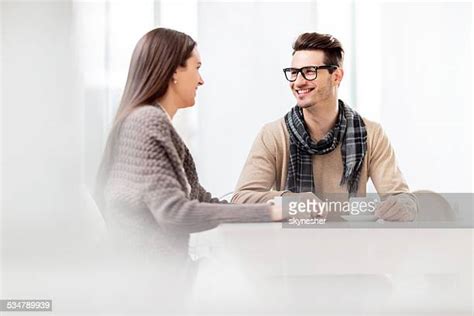 Smiling Couple Holding Hands And Drinking Coffee In Cafe Photos And