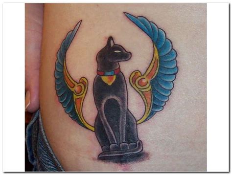 An Egyptian Cat Tattoo On The Side Of A Woman S Thigh With Wings Around It