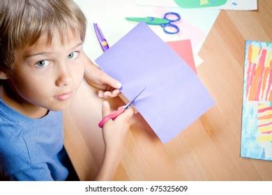 Boy Cutting Colored Paper Scissors Table Stock Photo